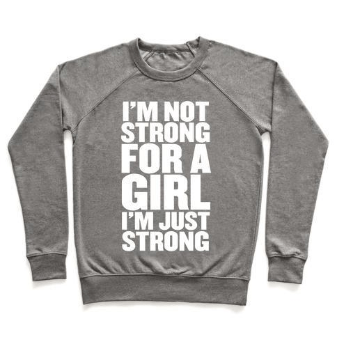 A stylish unisex crewneck sweatshirt featuring the phrase 'I'M NOT STRONG FOR A GIRL, I'M JUST STRONG' printed on the front, made from soft french terry fabric.