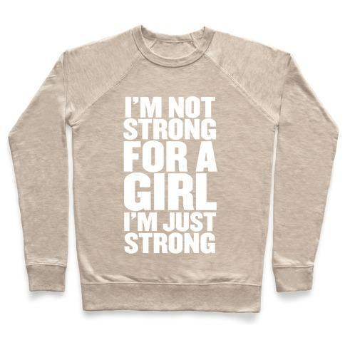 A stylish unisex crewneck sweatshirt featuring the phrase 'I'M NOT STRONG FOR A GIRL, I'M JUST STRONG' printed on the front, made from soft french terry fabric.