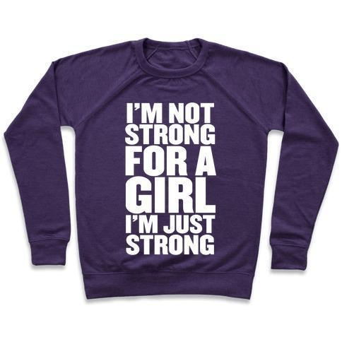 A stylish unisex crewneck sweatshirt featuring the phrase 'I'M NOT STRONG FOR A GIRL, I'M JUST STRONG' printed on the front, made from soft french terry fabric.