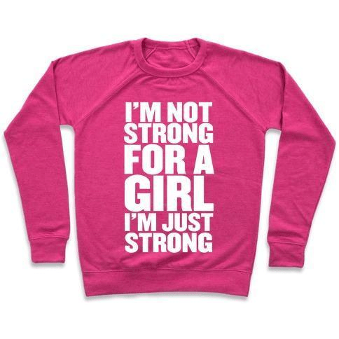 A stylish unisex crewneck sweatshirt featuring the phrase 'I'M NOT STRONG FOR A GIRL, I'M JUST STRONG' printed on the front, made from soft french terry fabric.