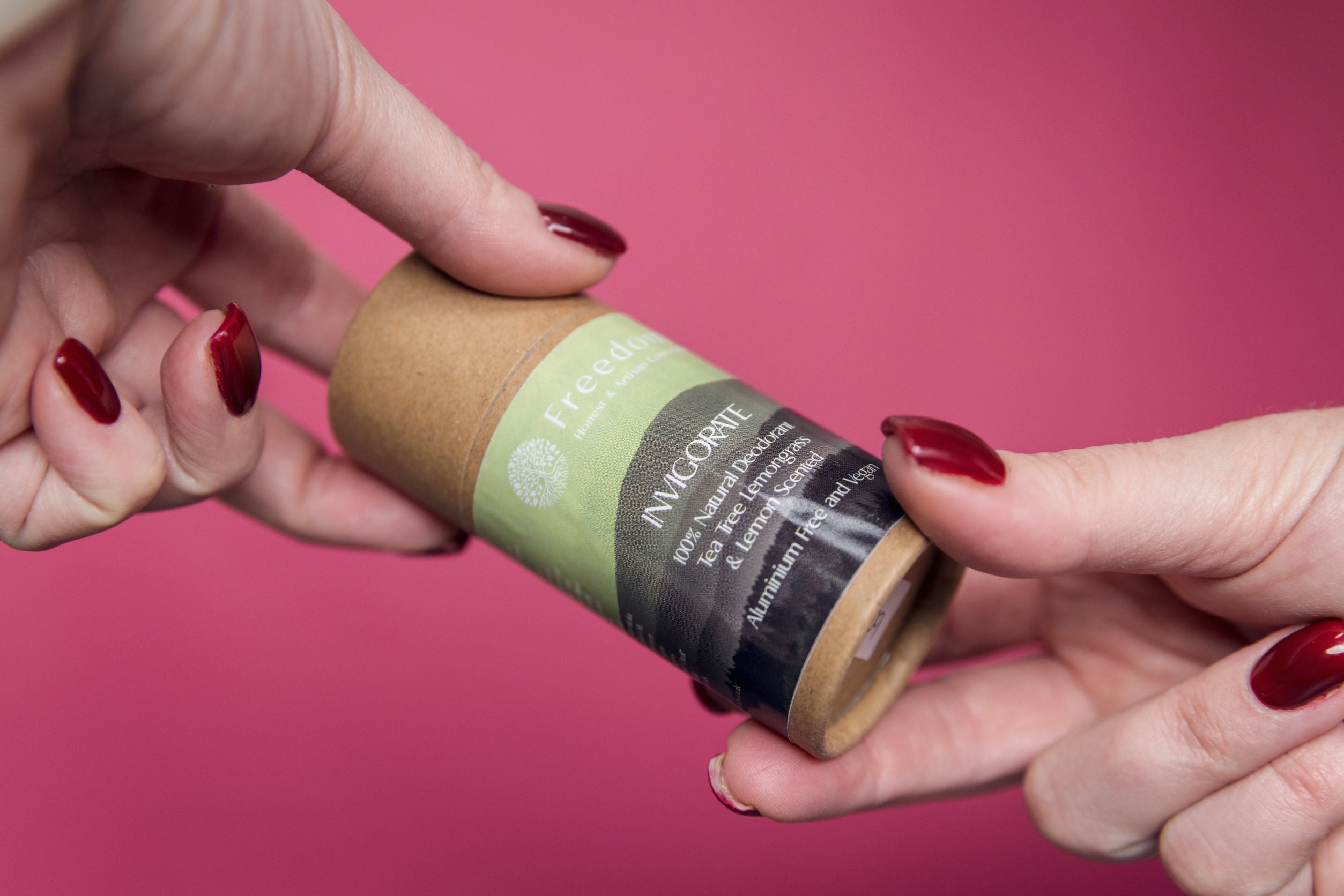 Invigorate Natural Vegan Deodorant in a biodegradable cardboard tube, featuring a fresh Tea Tree, Lemongrass, and Lemon scent.