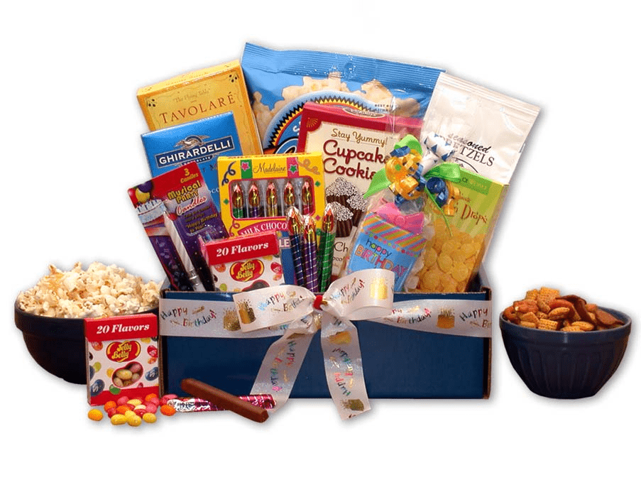 A beautifully arranged birthday gift pack featuring assorted snacks, a musical candle, and a Happy Birthday gift bag.