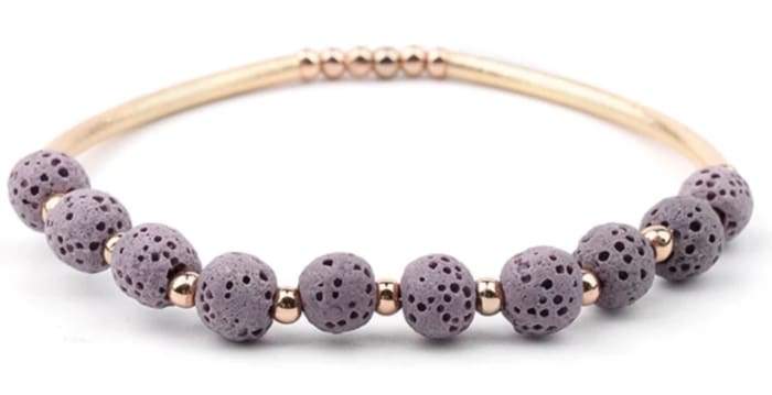 Purple lava stone essential oil bracelet with gold accents, showcasing its unique texture and design.