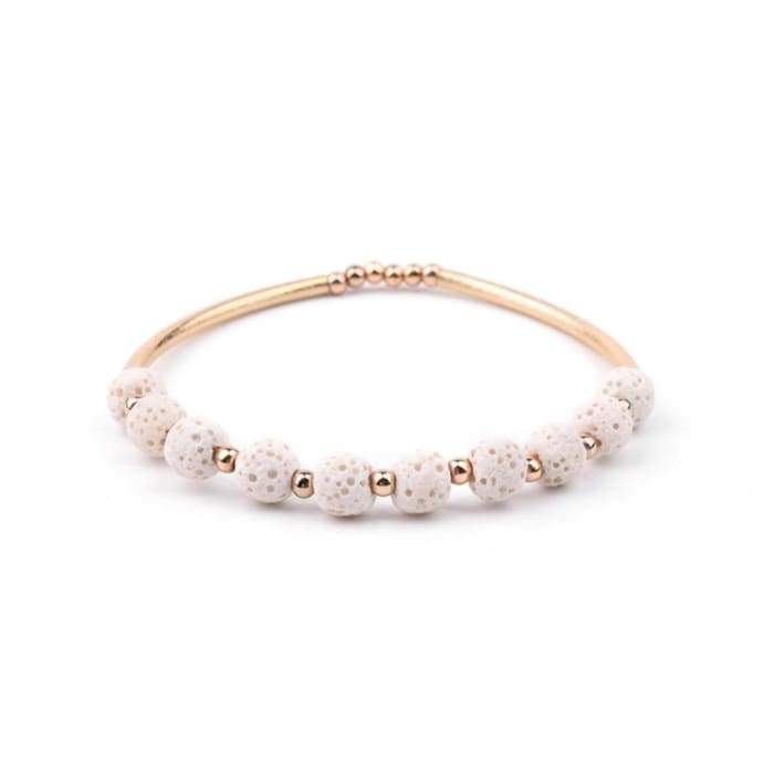 Lava Stone Essential Oil Bracelet featuring white lava stones and gold accents, perfect for aromatherapy.