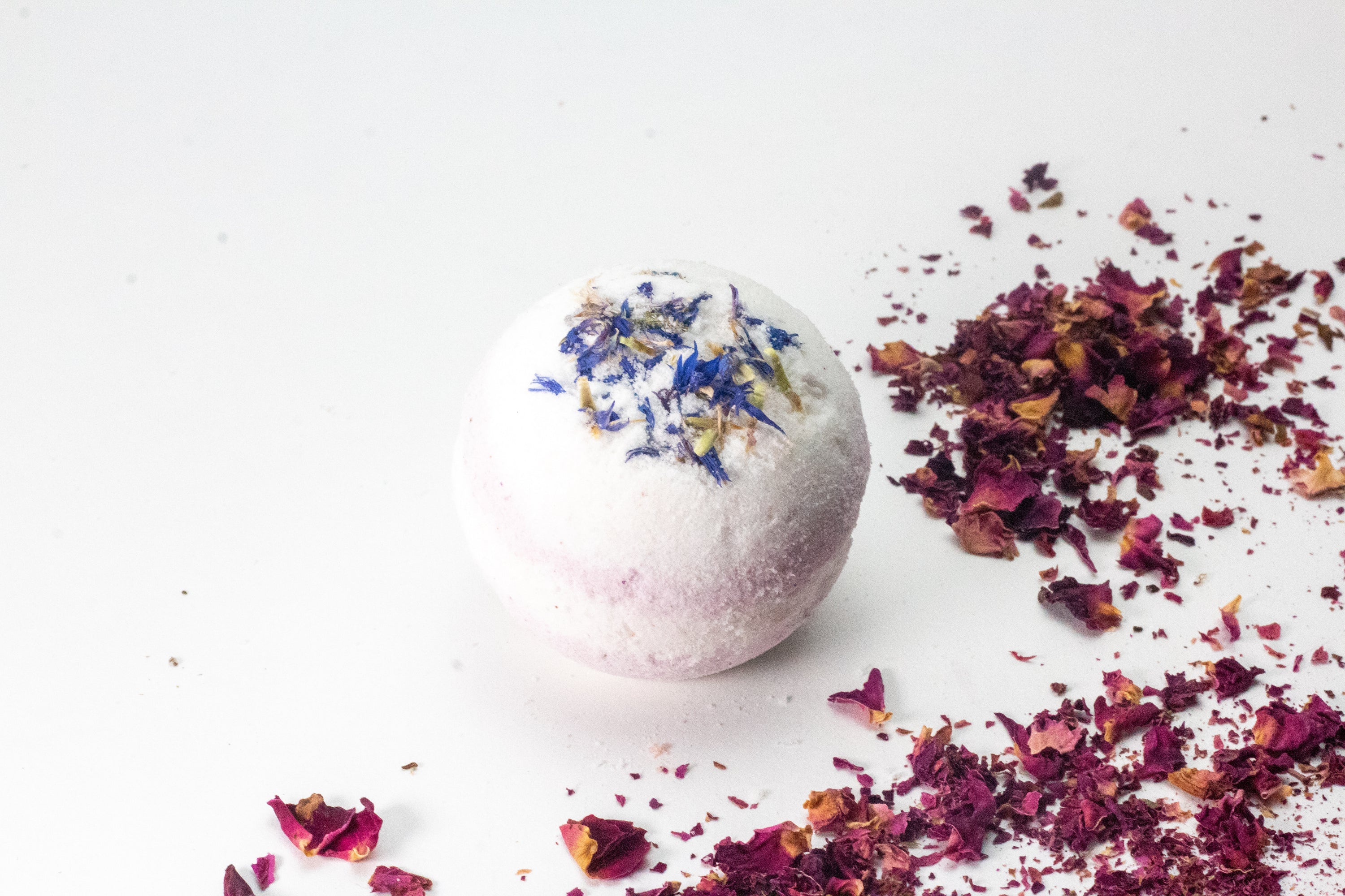 Lavender Eucalyptus Bath Bomb with flower petals, showcasing its vibrant colors and organic ingredients.