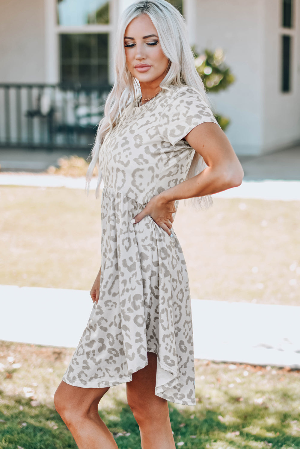 Leopard Print Empire Waist Babydoll Dress featuring a round neck, short sleeves, and irregular hem, perfect for summer outings.