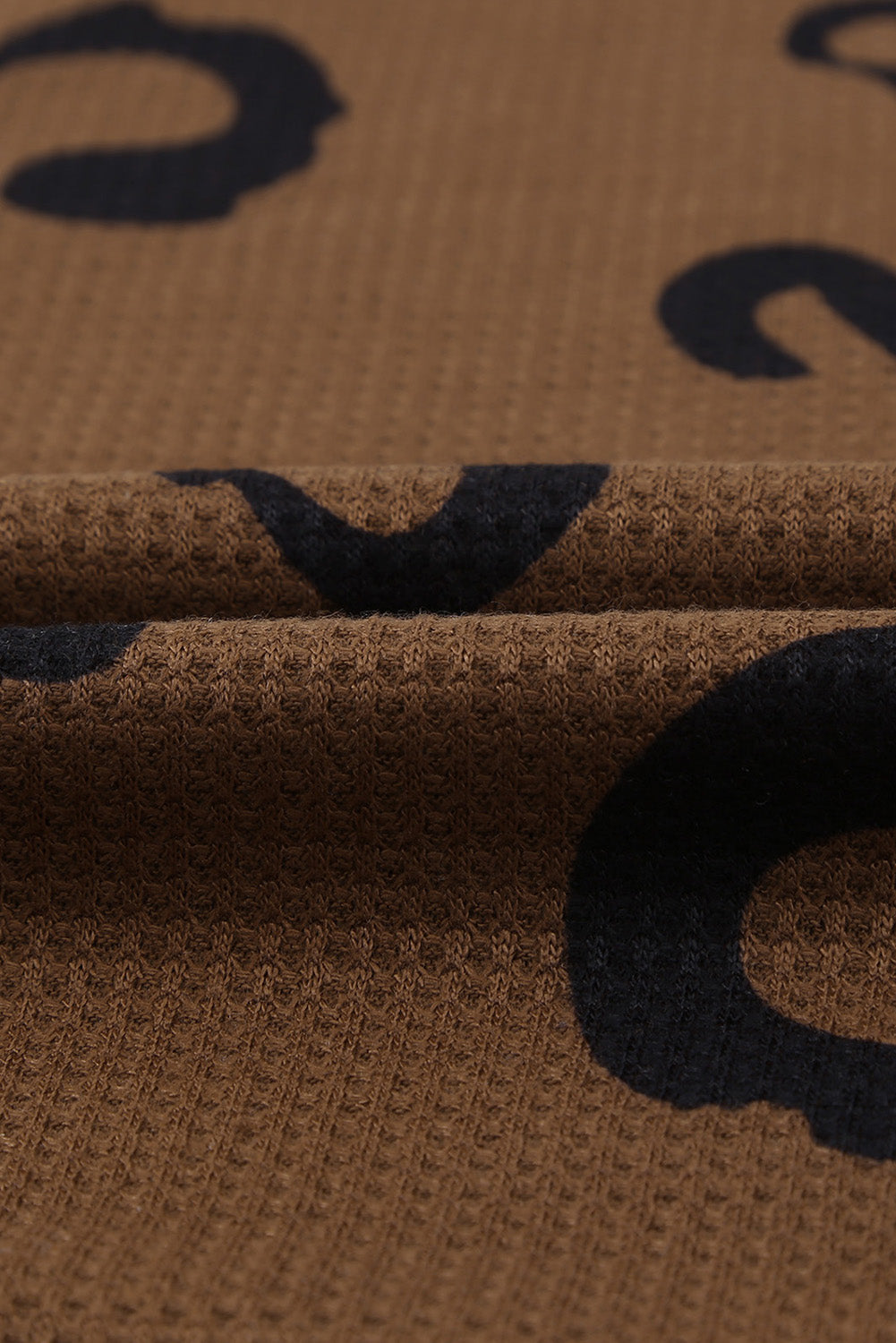 A stylish leopard print top featuring a side split design, V-neckline, and long sleeves, perfect for casual wear.