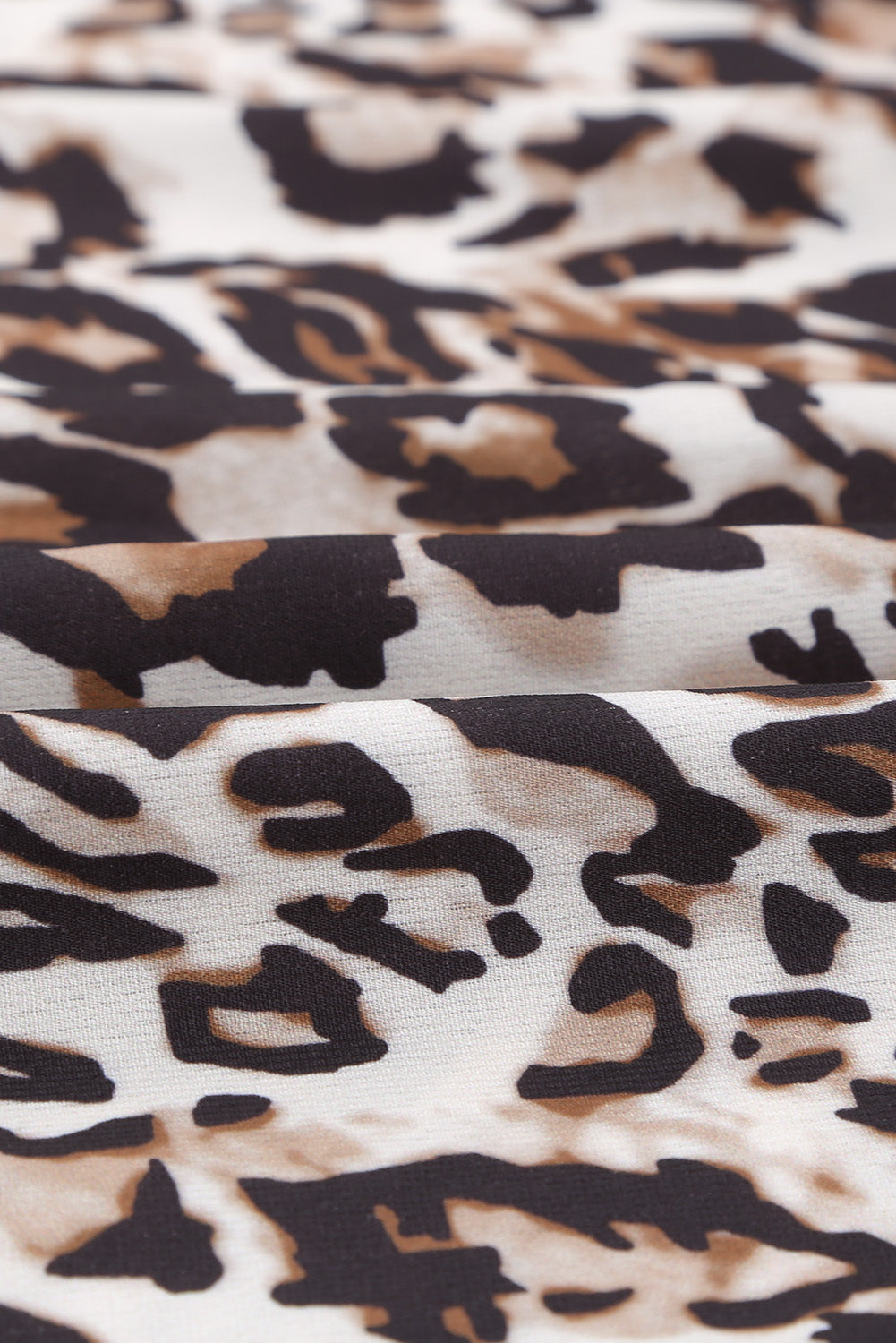 A stylish Leopard Ruffle V Neck Long Sleeve Tunic Mini Dress featuring a feminine ruffle design and a flattering V-neckline, perfect for casual outings.