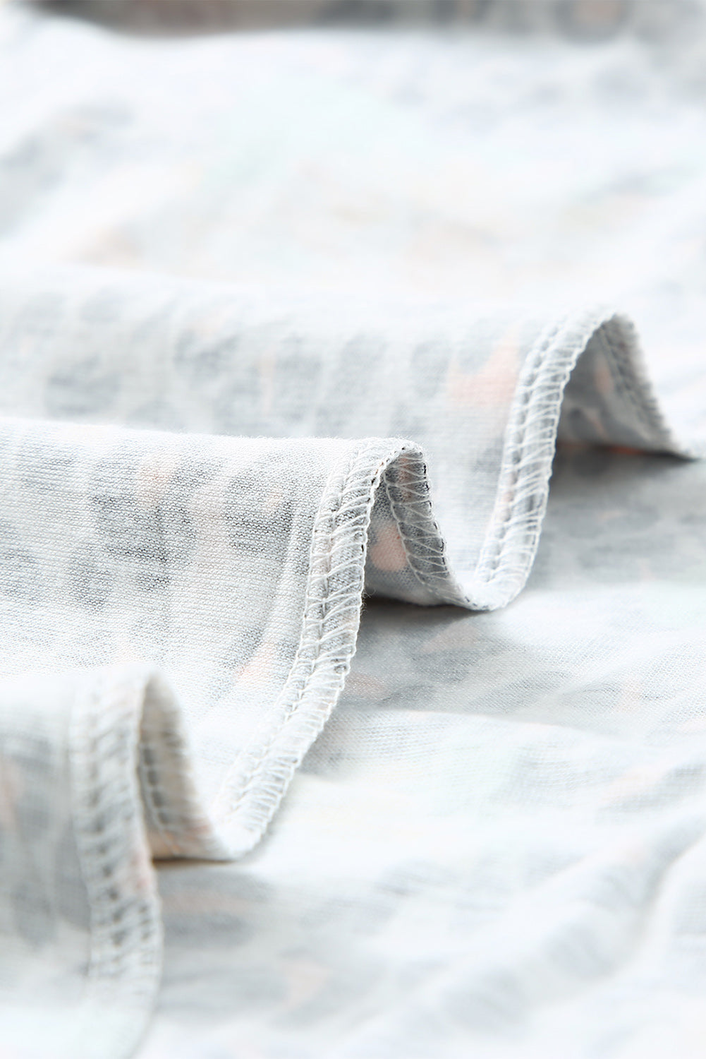 Leopard Sunflower Hollow Out Criss-cross Tee featuring a stylish leopard pattern and vibrant sunflower print, perfect for modern ladies.