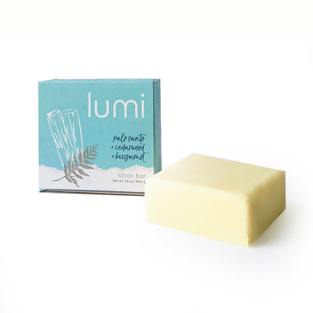 A solid lotion bar in a square shape, featuring a sweet lavender citrus scent, placed on a wooden surface with natural elements around it.