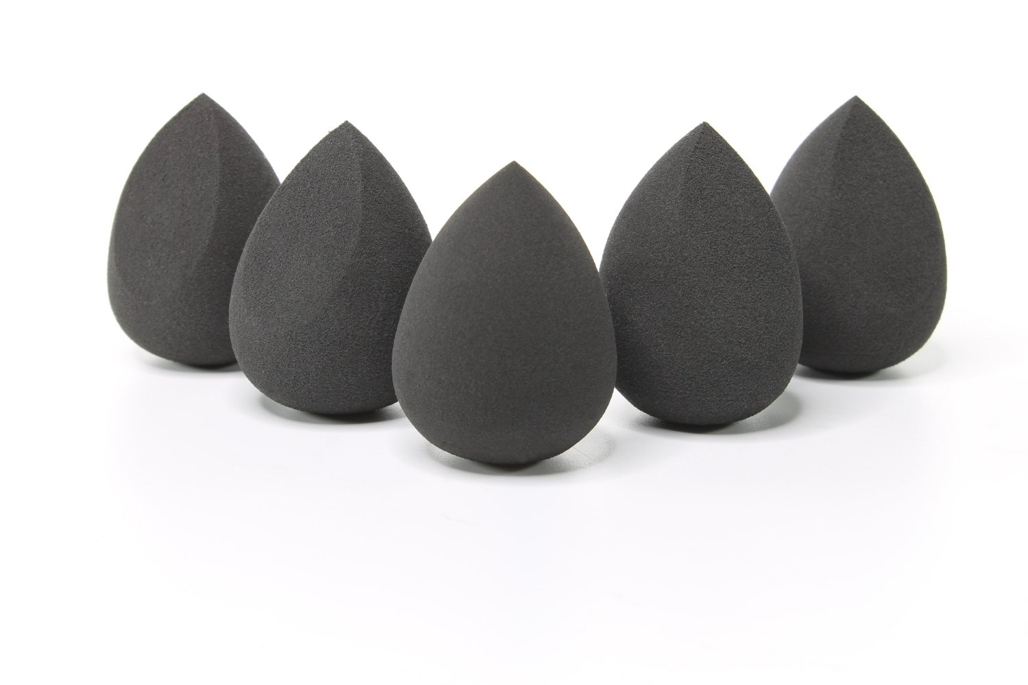 Three black makeup blending sponges arranged together, showcasing their unique shapes and soft texture for flawless makeup application.