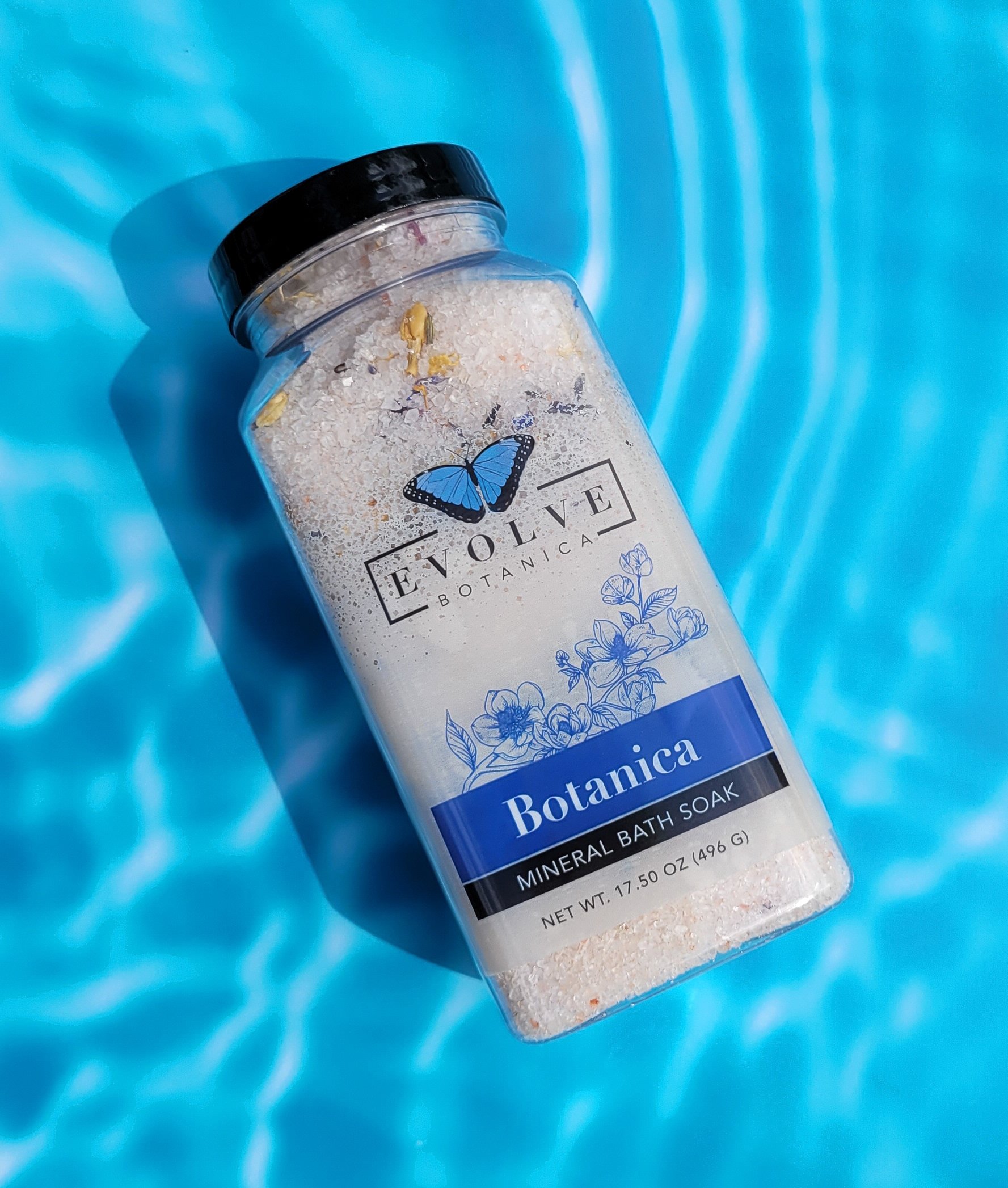 A jar of Mineral Soak - Botanica bath salt featuring a blend of Himalayan pink salt, Dead Sea salts, and colorful flower petals.