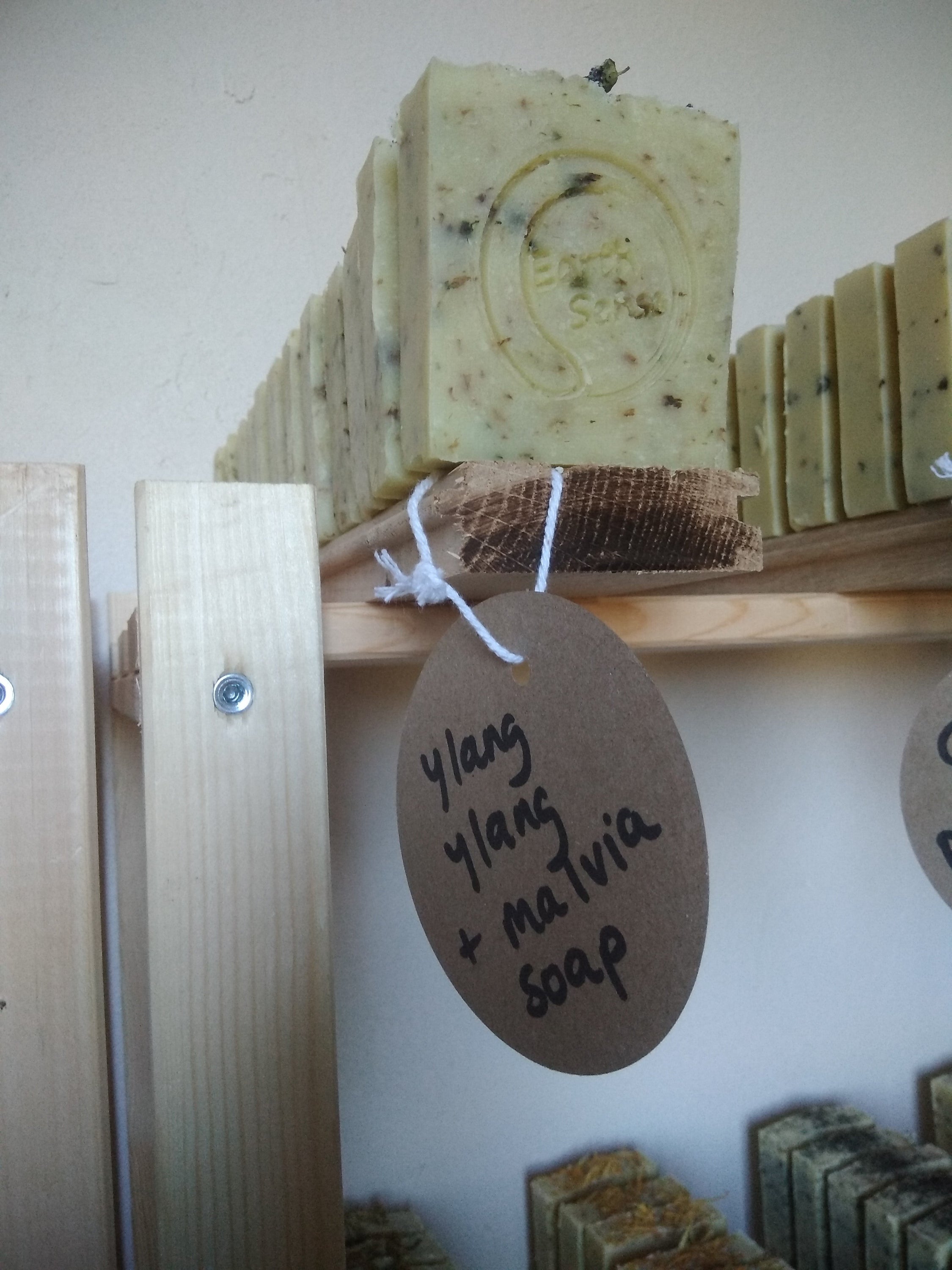 Four 90g bars of organic certified solid soap in sandalwood scent, featuring shredded comfrey leaves, beautifully packaged.