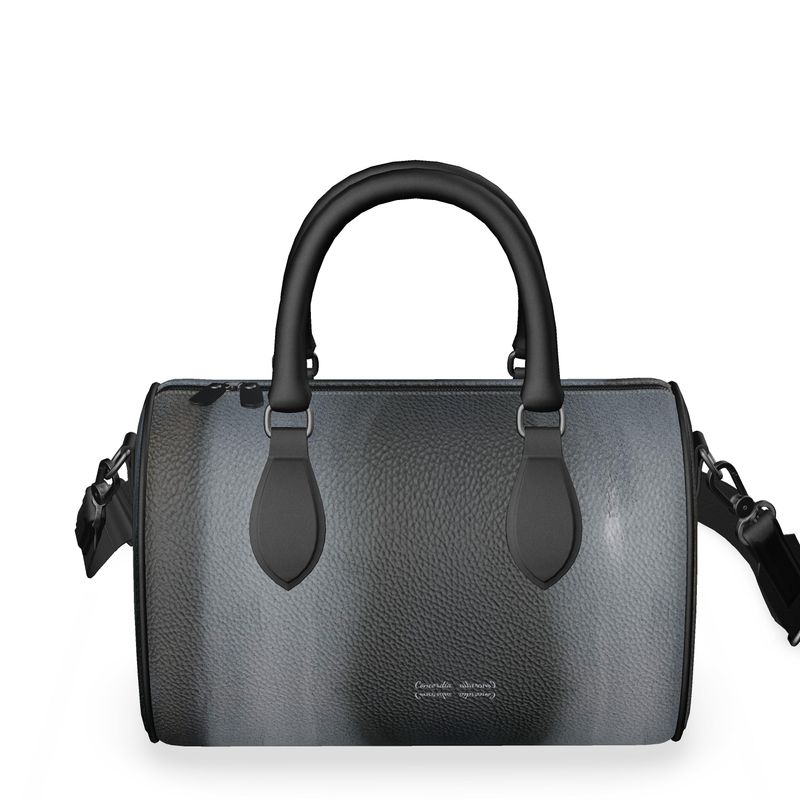 Mini Denbigh Duffle Bag with double black leather handles and faux suede lining, showcasing its stylish design and craftsmanship.