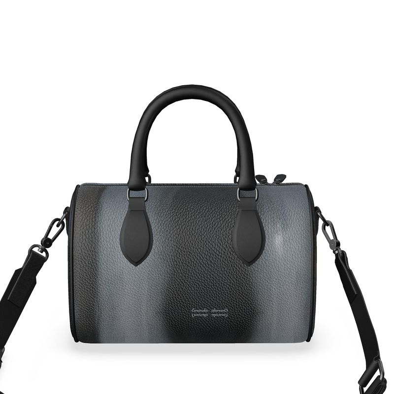 Mini Denbigh Duffle Bag with double black leather handles and faux suede lining, showcasing its stylish design and craftsmanship.