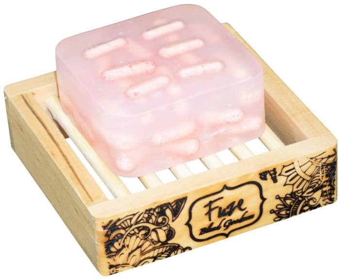 Monthly Comfort Burst Bar with essential oils and fizzing bath bomb pockets, displayed on a wooden soap dish.