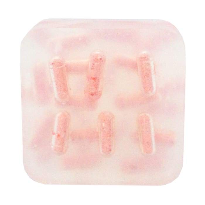 Monthly Comfort Burst Bar with essential oils and fizzing bath bomb pockets, displayed on a wooden soap dish.