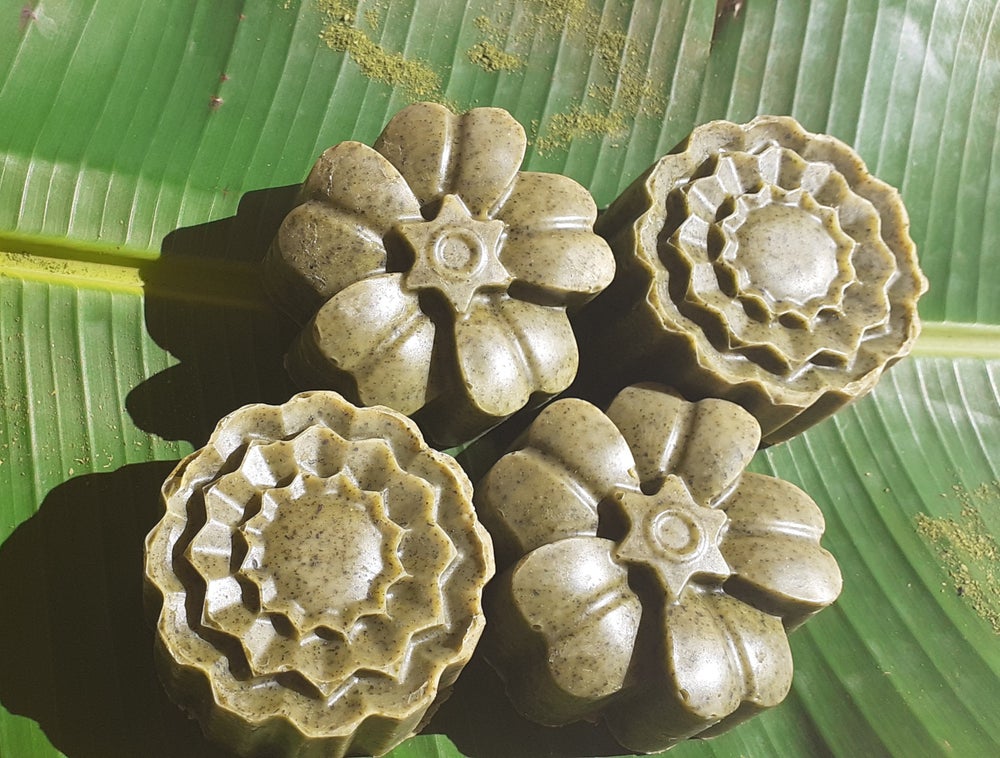 Moringa Bath Soap bar with natural ingredients, showcasing its rich texture and earthy color.