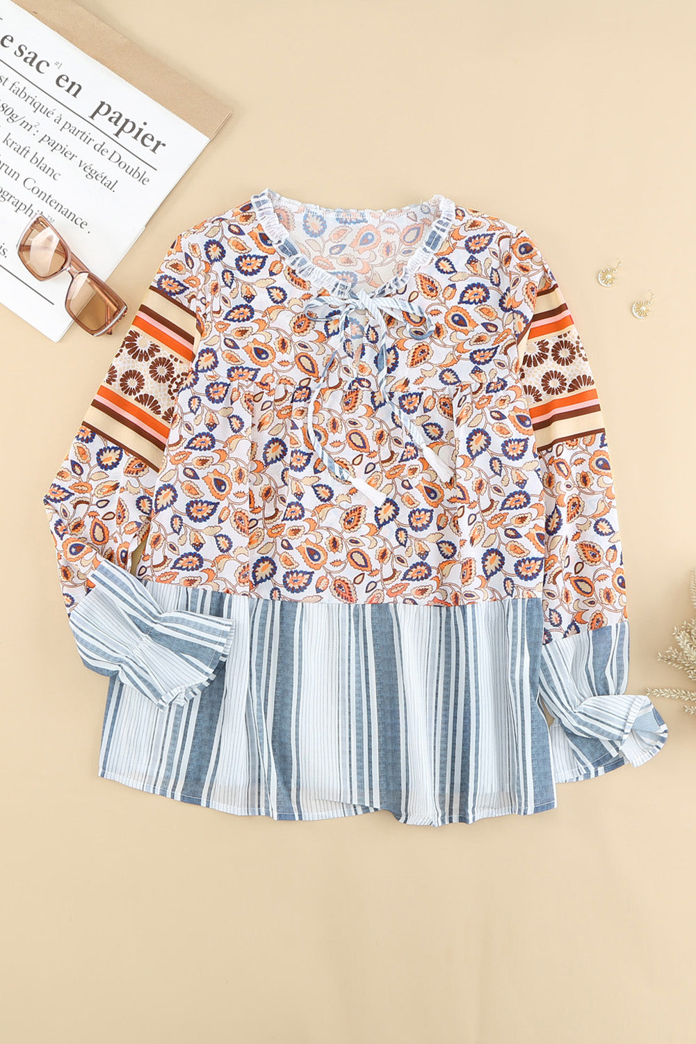 A vibrant multicolor loose fit floral striped blouse featuring a v-cut neckline, tie closure, and long flared sleeves, perfect for casual outings.