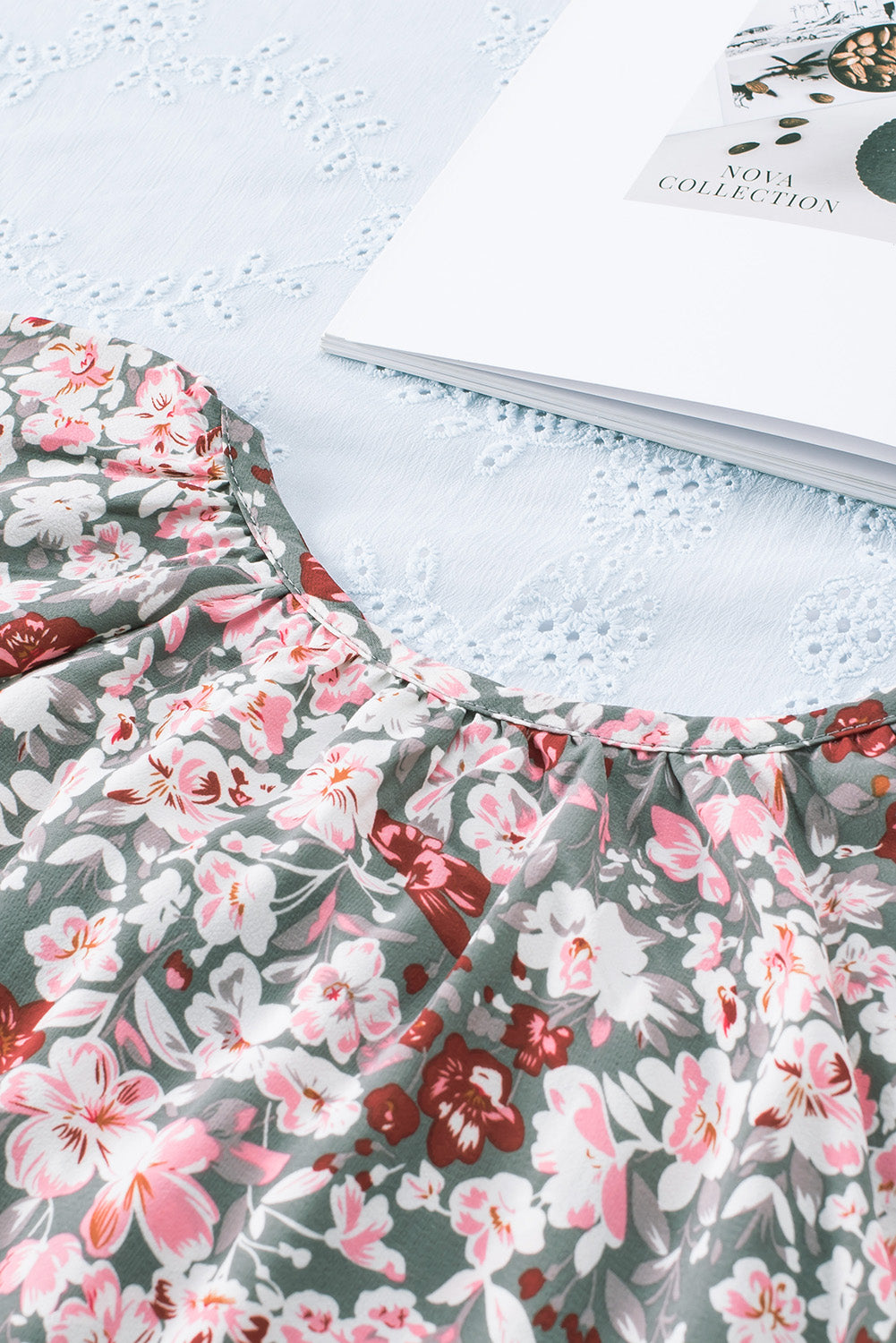 A vibrant multicolor V-neck blouse with short ruffled sleeves and a fluttering hem, showcasing an elegant fashion print.