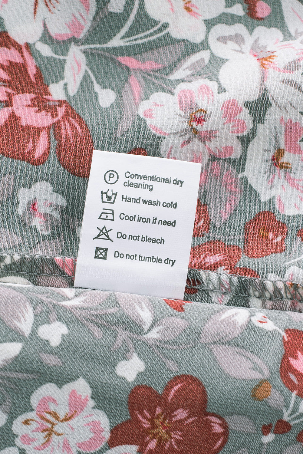 A vibrant multicolor V-neck blouse with short ruffled sleeves and a fluttering hem, showcasing an elegant fashion print.