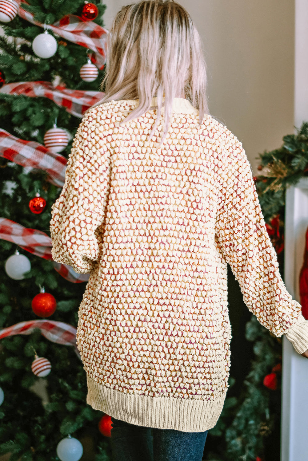 A stylish multicolour abstract printed cardigan with bishop sleeves, open front design, showcasing vibrant colors and cozy knitted fabric.