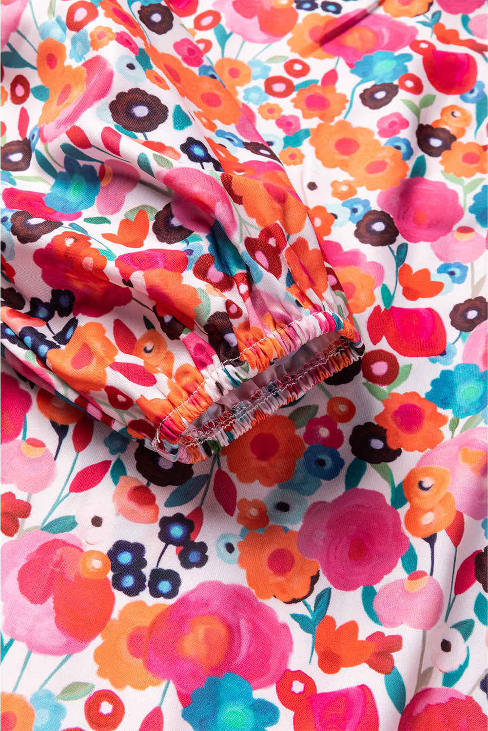 A vibrant multicolour floral dress featuring a ruffle split neck, long sleeves, and a boho chic style, perfect for casual and semi-formal occasions.