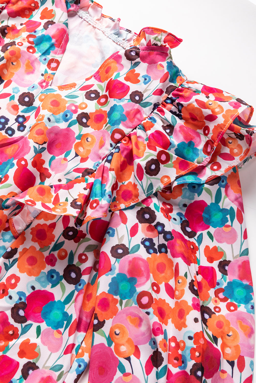 A vibrant multicolour floral dress featuring a ruffle split neck, long sleeves, and a boho chic style, perfect for casual and semi-formal occasions.
