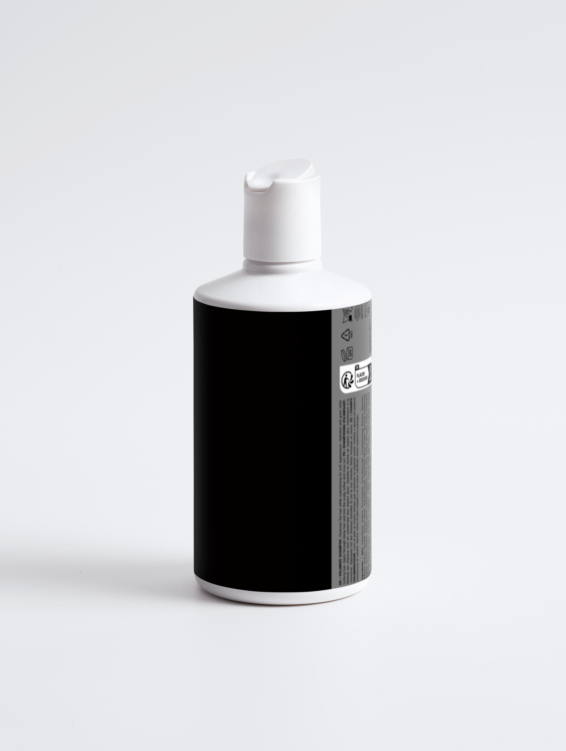 A bottle of Nourish and Volumize Shampoo with a sleek white design, showcasing its nourishing ingredients for healthy hair.