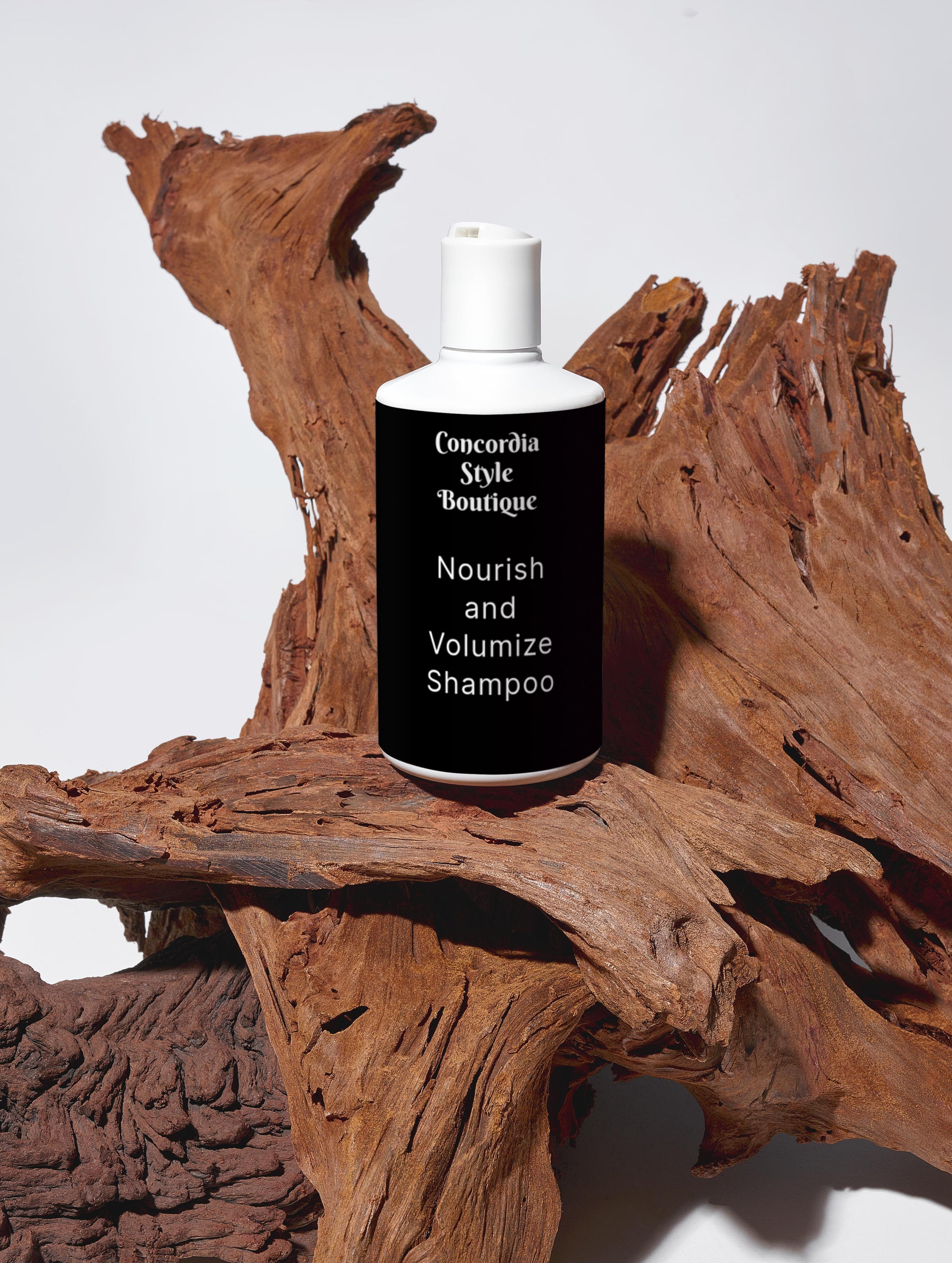 A bottle of Nourish and Volumize Shampoo with a sleek white design, showcasing its nourishing ingredients for healthy hair.