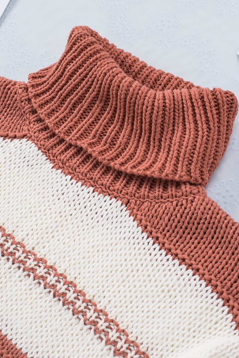 Orange turtleneck knit sweater with color block design and balloon sleeves, perfect for autumn and winter fashion.