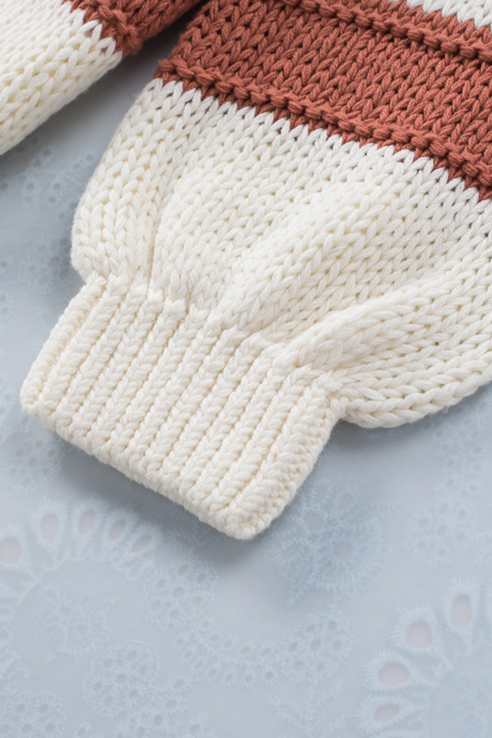 Orange turtleneck knit sweater with color block design and balloon sleeves, perfect for autumn and winter fashion.