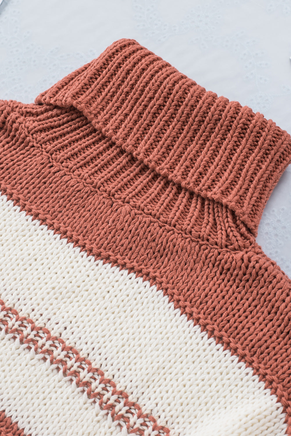 Orange turtleneck knit sweater with color block design and balloon sleeves, perfect for autumn and winter fashion.