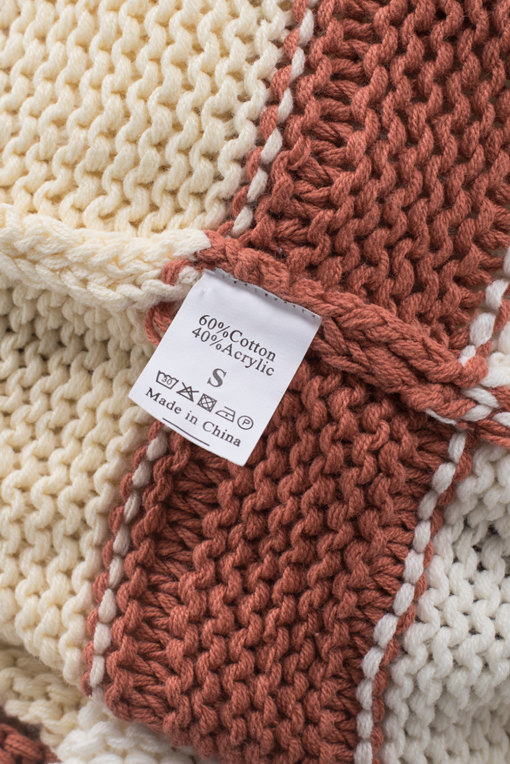 Orange turtleneck knit sweater with color block design and balloon sleeves, perfect for autumn and winter fashion.