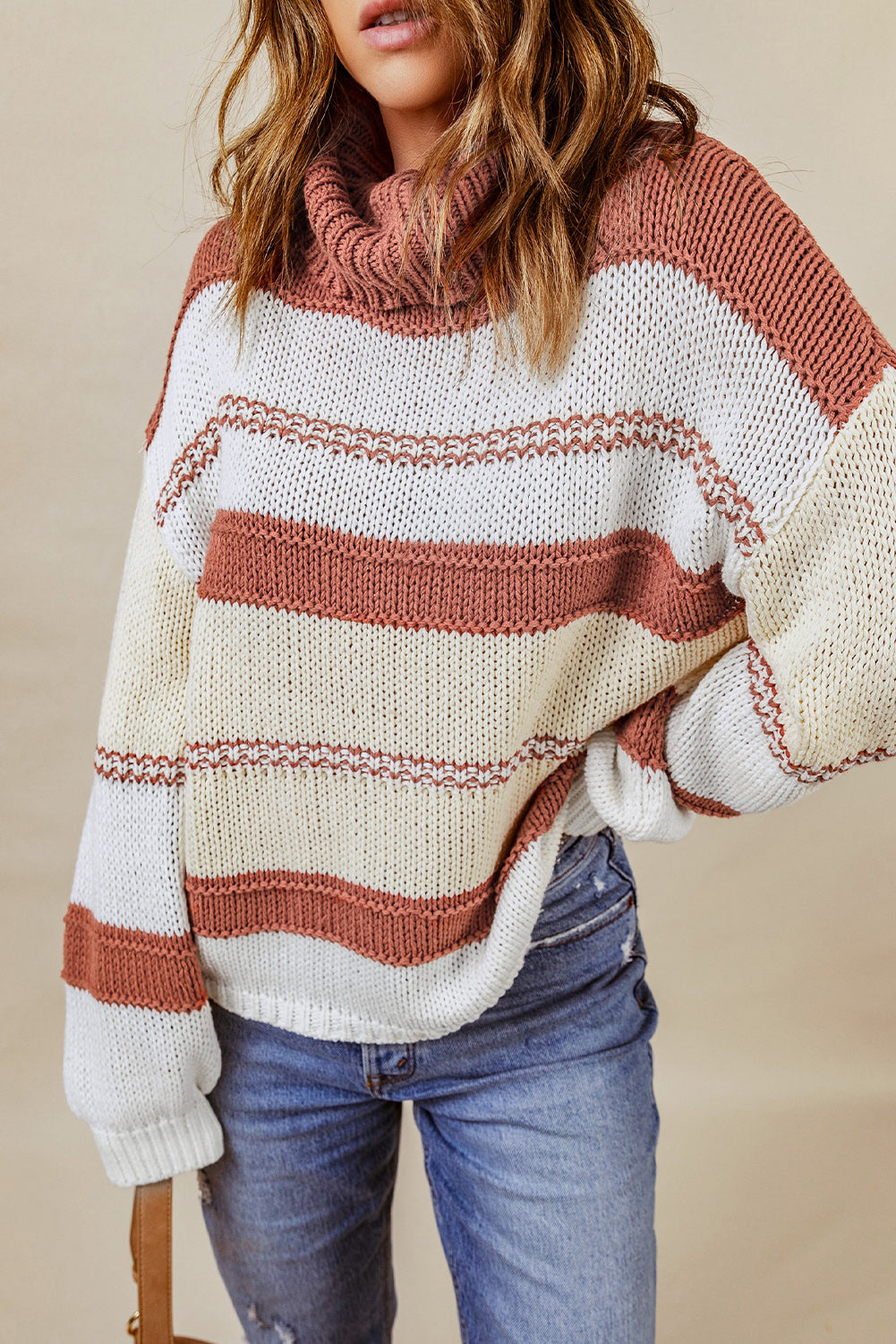 Orange turtleneck knit sweater with color block design and balloon sleeves, perfect for autumn and winter fashion.