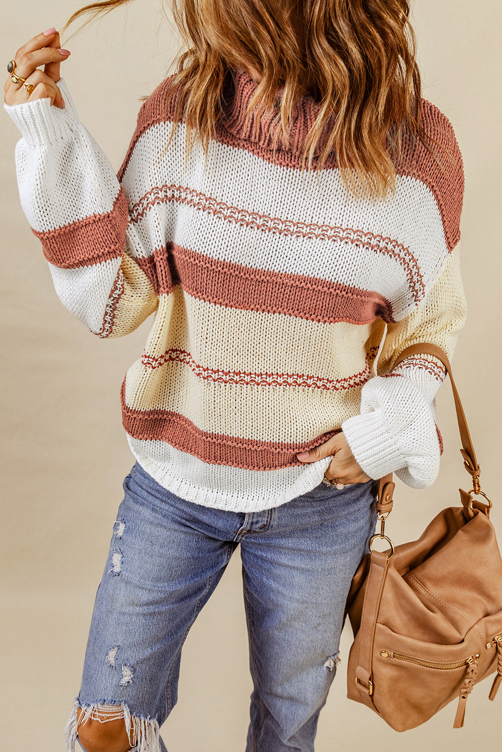 Orange turtleneck knit sweater with color block design and balloon sleeves, perfect for autumn and winter fashion.