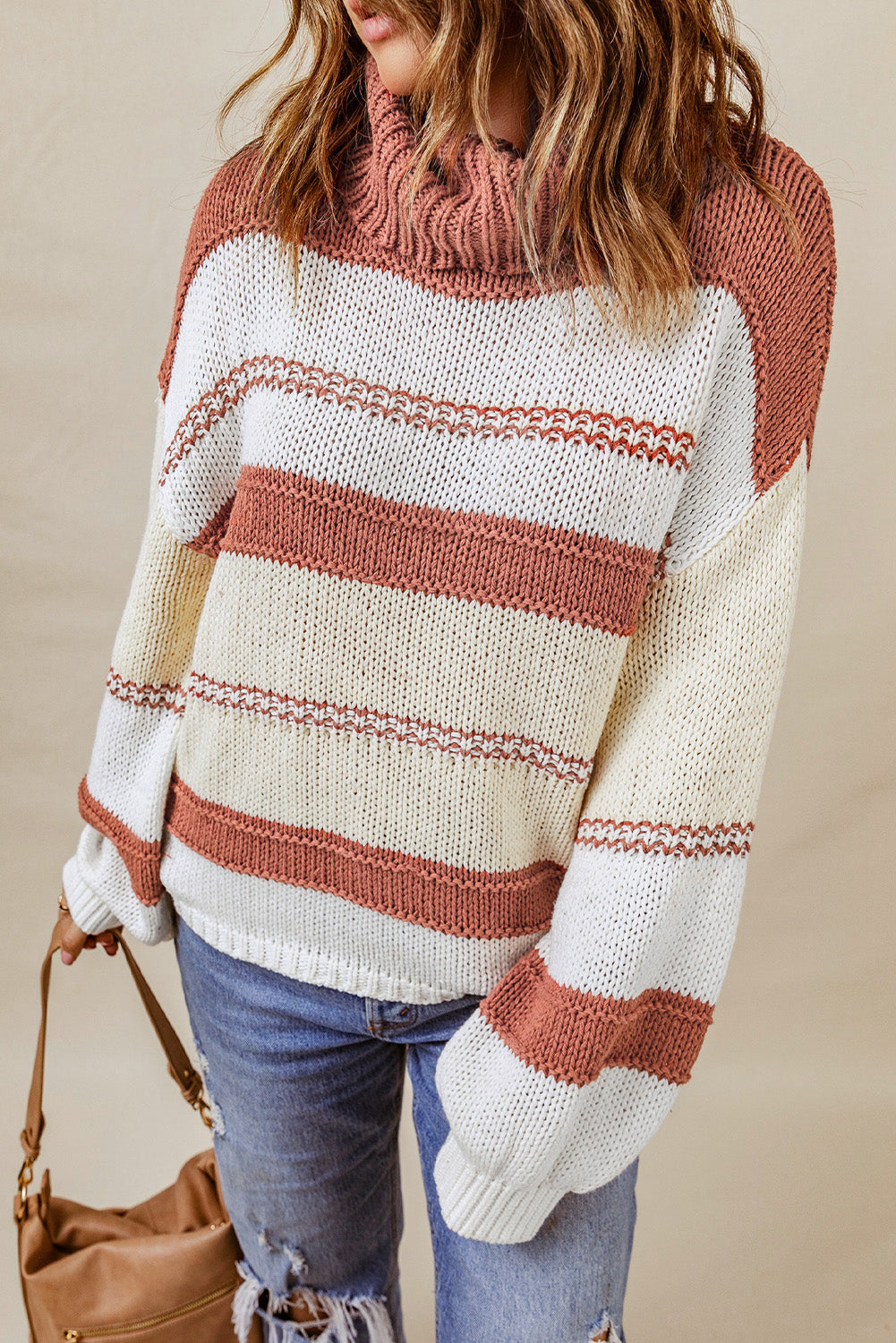 Orange turtleneck knit sweater with color block design and balloon sleeves, perfect for autumn and winter fashion.