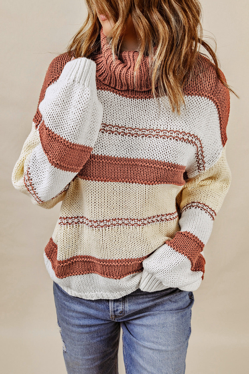 Orange turtleneck knit sweater with color block design and balloon sleeves, perfect for autumn and winter fashion.