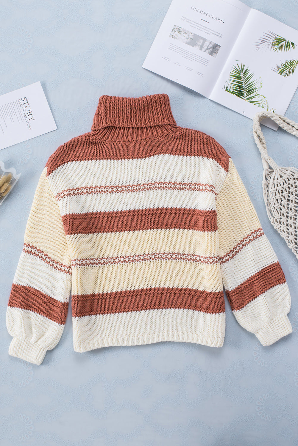 Orange turtleneck knit sweater with color block design and balloon sleeves, perfect for autumn and winter fashion.