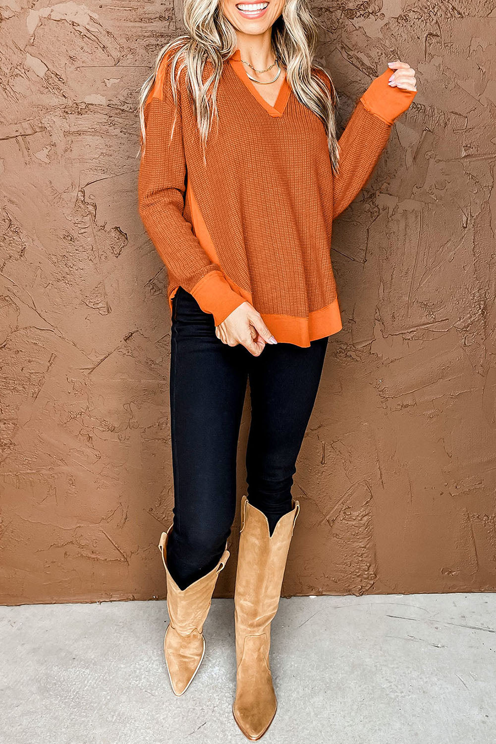 Orange waffle knit long sleeve top with patchwork design and v neckline, perfect for autumn and winter fashion.
