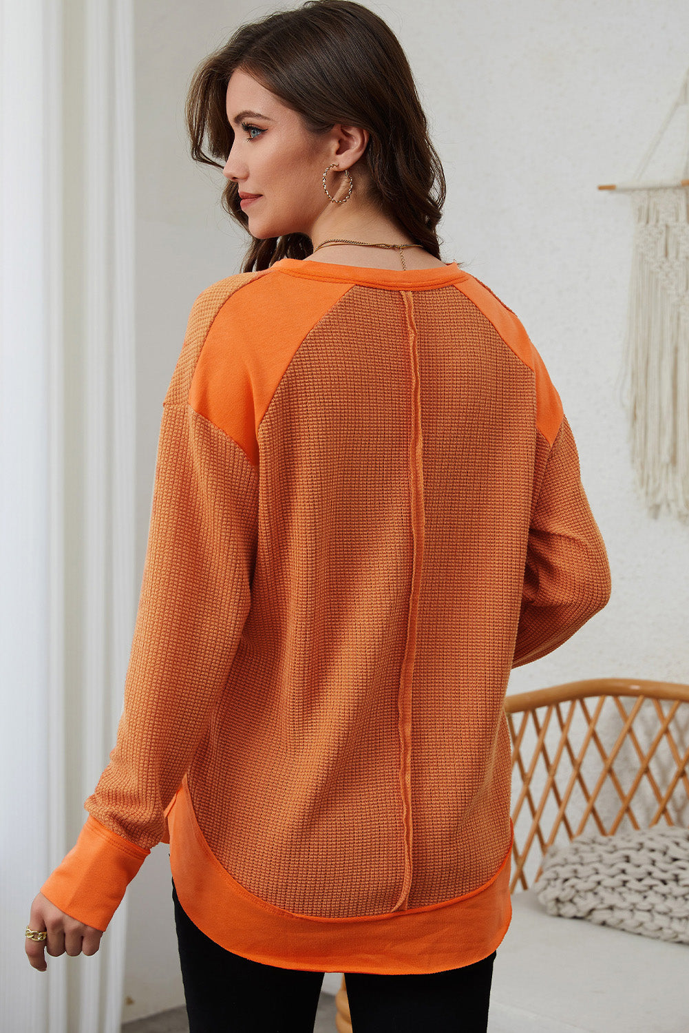 Orange waffle knit long sleeve top with patchwork design and v neckline, perfect for autumn and winter fashion.