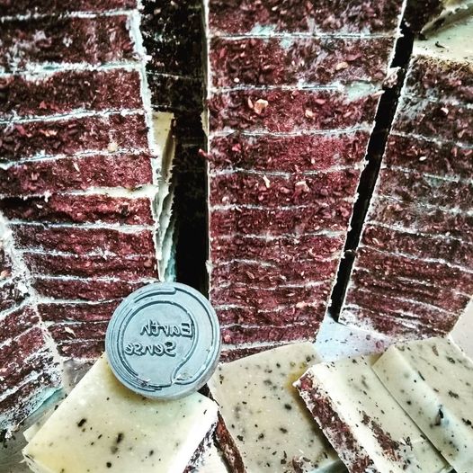 Organic Certified Solid Soap with Jasmine and Chamomile Flowers, showcasing its natural ingredients and elegant packaging.