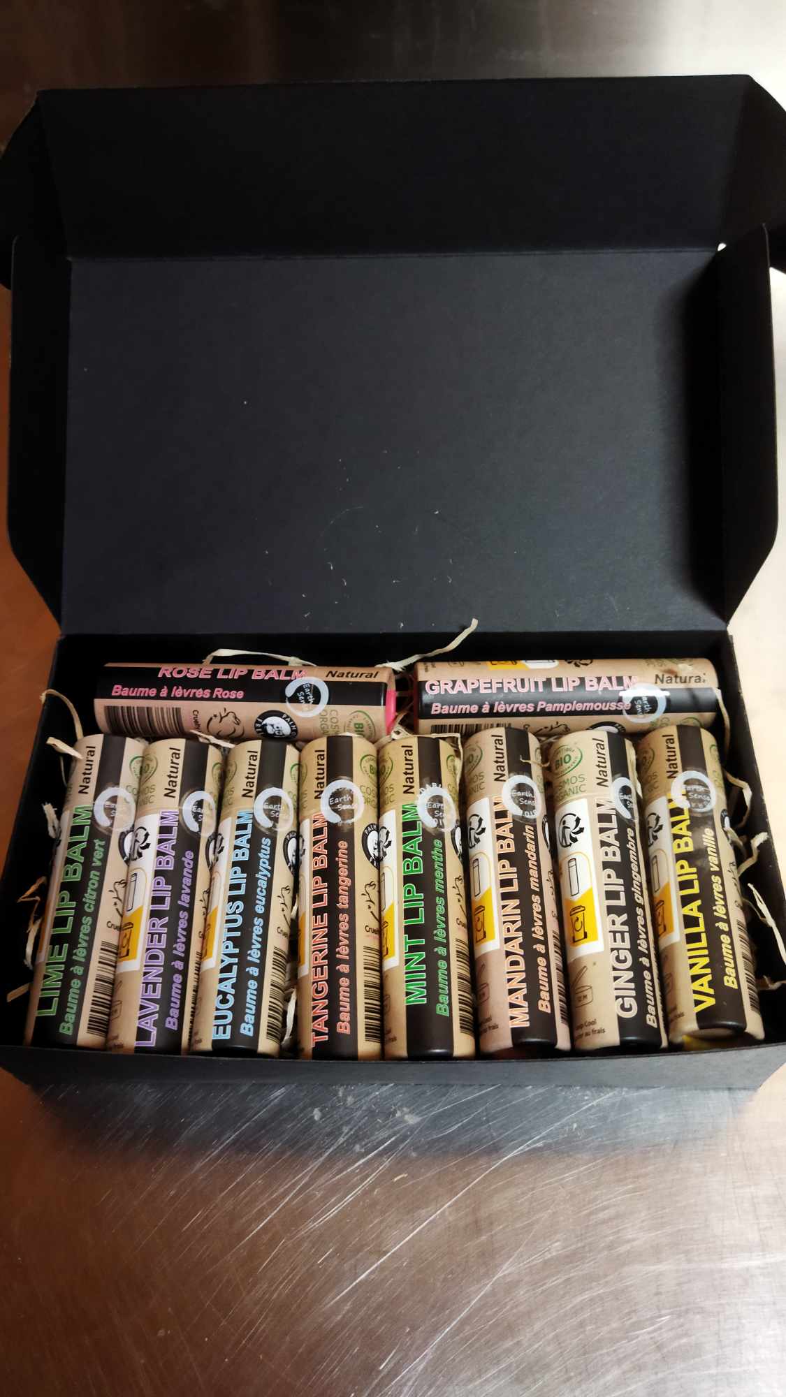 Organic Pink Grapefruit Lip Balm in a paper tube, showcasing its natural ingredients and eco-friendly packaging.