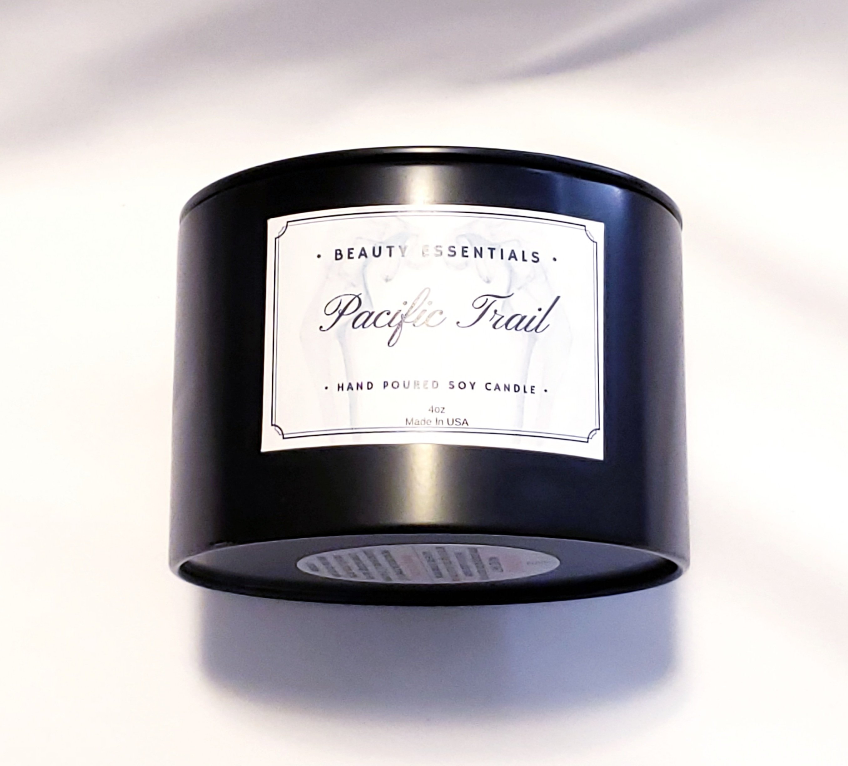 Pacific Trail Candle in a glass jar with a natural wood lid, showcasing its earthy and floral scent profile.
