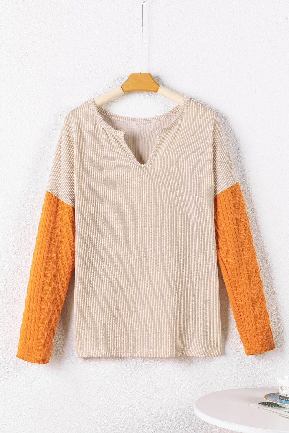 Parchment Corduroy Patchwork Drop Shoulder V Neck Top featuring textured patch sleeves and a relaxed fit.