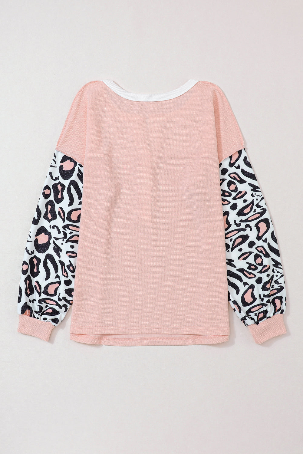 Parchment Leopard Sleeve Patchwork Waffle Knit Top featuring trendy leopard print sleeves and exposed seam detailing.