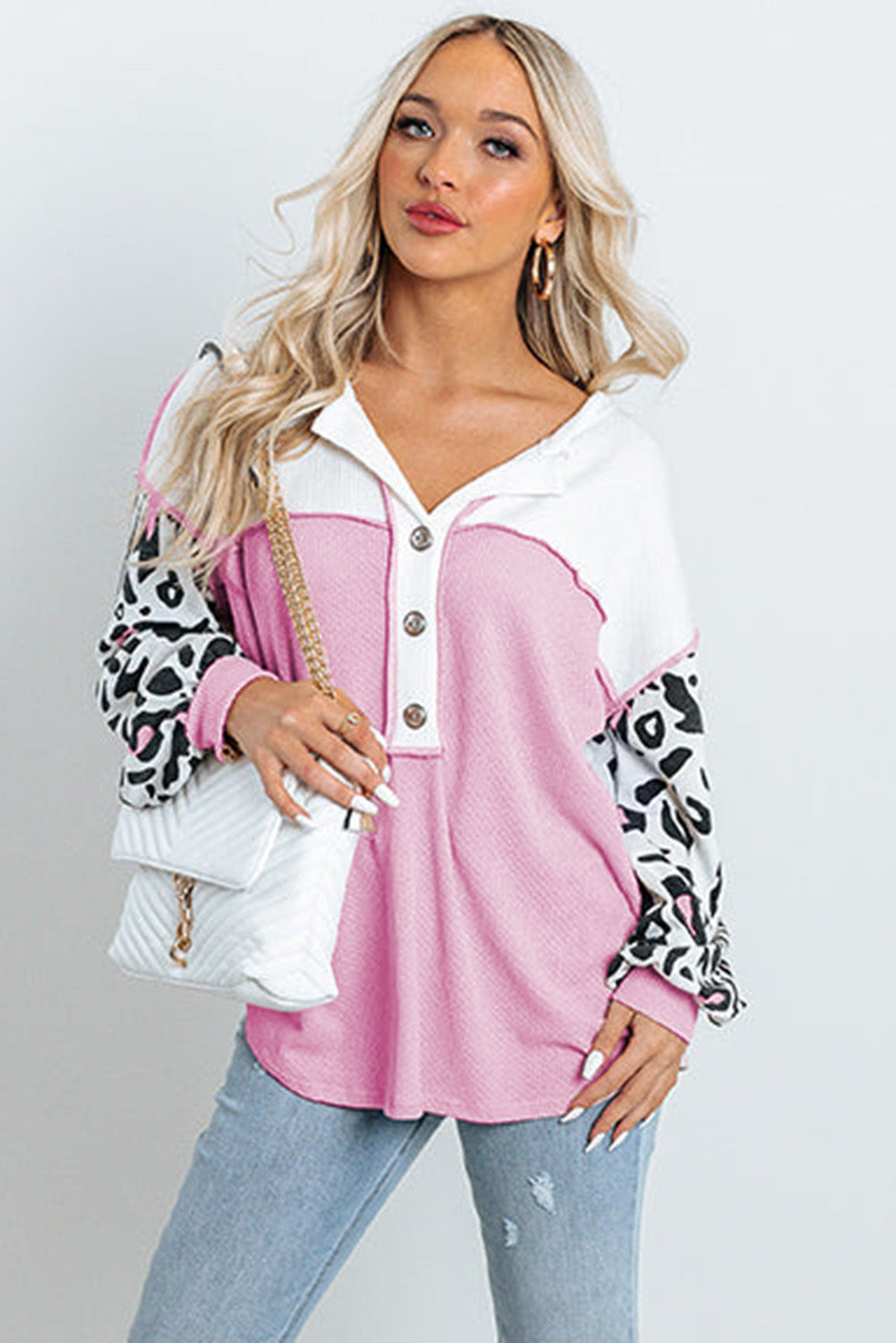 Parchment Leopard Sleeve Patchwork Waffle Knit Top featuring trendy leopard print sleeves and exposed seam detailing.