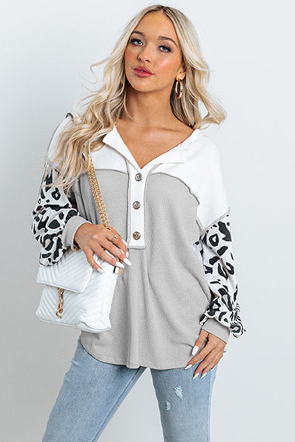 Parchment Leopard Sleeve Patchwork Waffle Knit Top featuring trendy leopard print sleeves and exposed seam detailing.