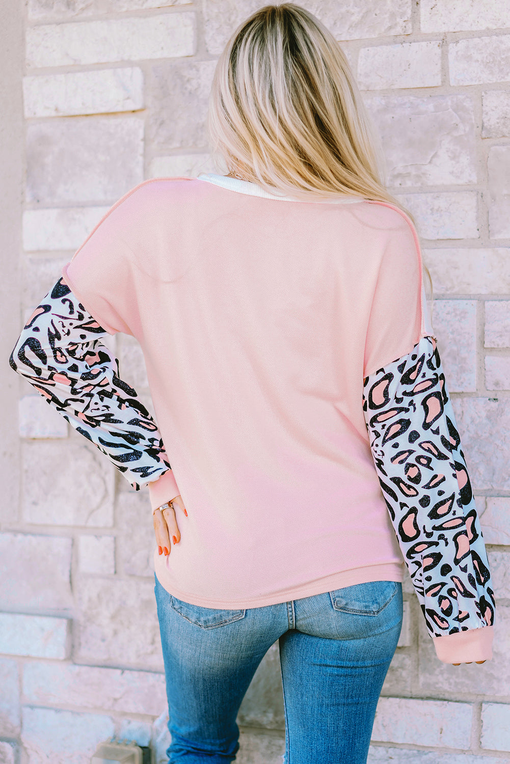 Parchment Leopard Sleeve Patchwork Waffle Knit Top featuring trendy leopard print sleeves and exposed seam detailing.