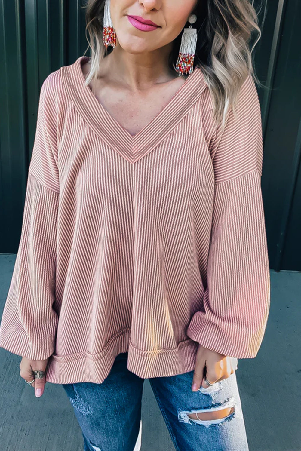 Peach Blossom Loose V Neck Bubble Sleeve Knit Ribbed Top showcasing a feminine silhouette with bubble sleeves and a soft ribbed texture.